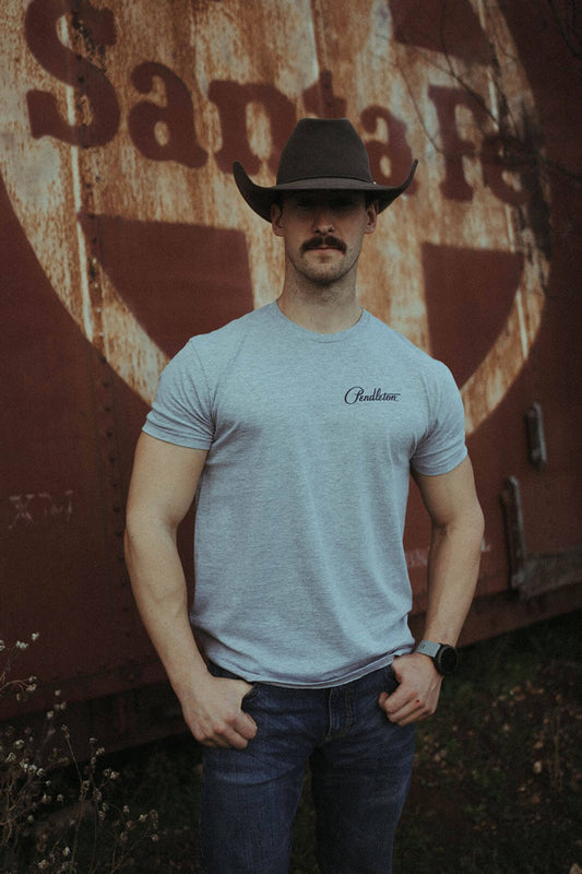 Man modeling the gray color pendleton graphic tee shirt with Pendleton logo on left side of shirt.