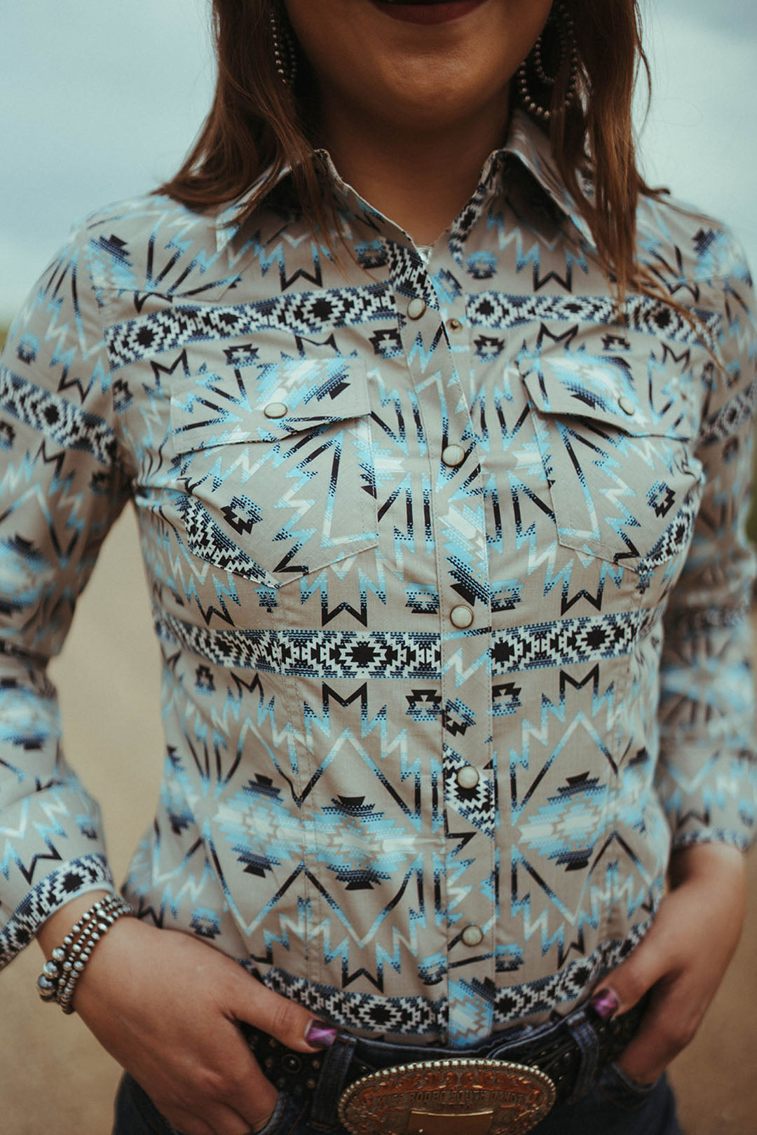 Close up image of the Aztec Print Snap Shirt.  Collared.  Blue aztec design.  