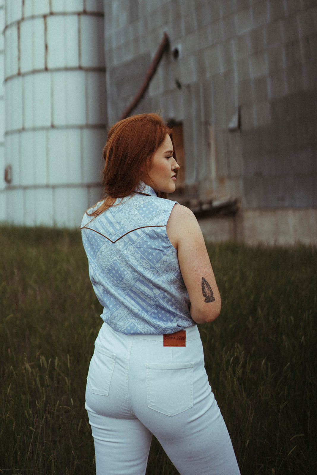 Woman modeling the back of the Printed Sky Blue Chambray Snap Shirt.  Collared Shirt. 