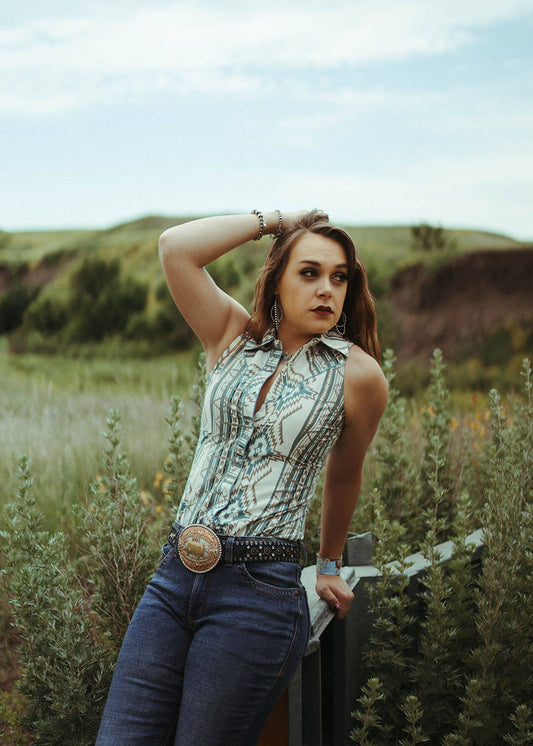Woman modeling the Aztec Sleeveless Snap shirt by Rock & Roll Denim.  The shirt is pearl snap button up.