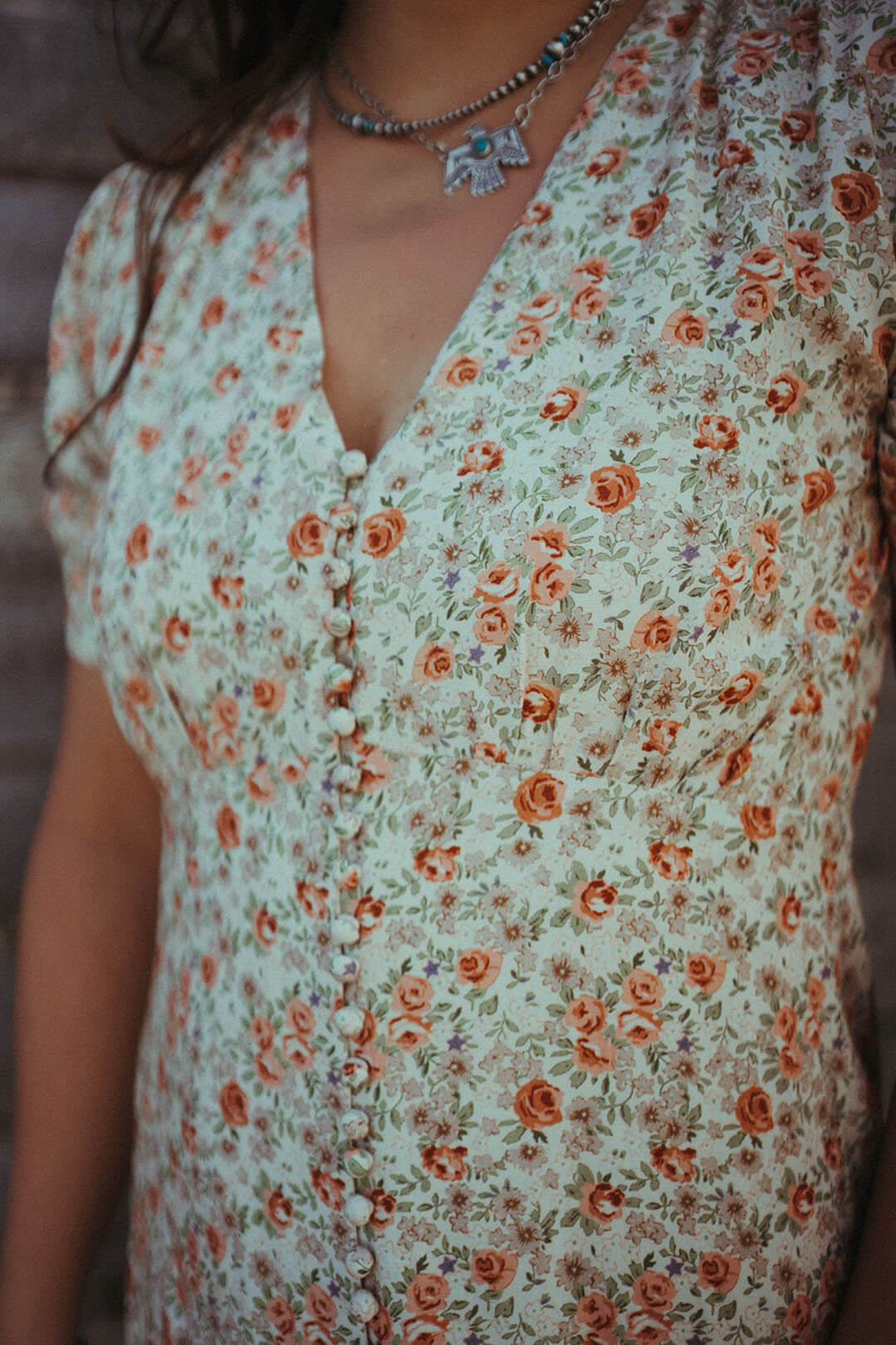 CLose up image of the Le Petit Jardin Midi Dress.  The Dress is beautiful floral colors of orange and cream.
