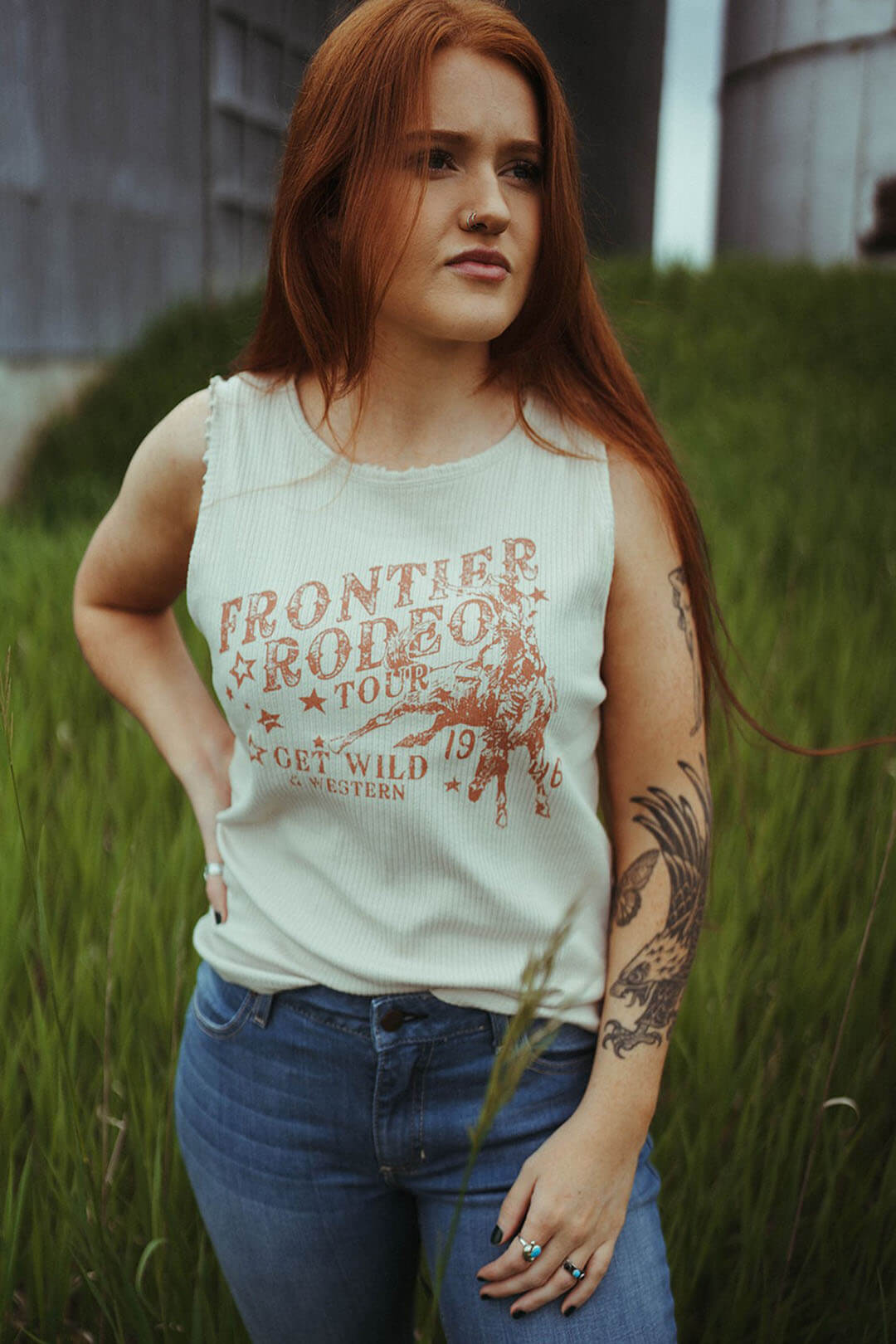 Woman modeling the Rib Graphic Tank by Rock & Roll Denim.  Says "Frontier Rodeo Tour" Get Wild & Western.  