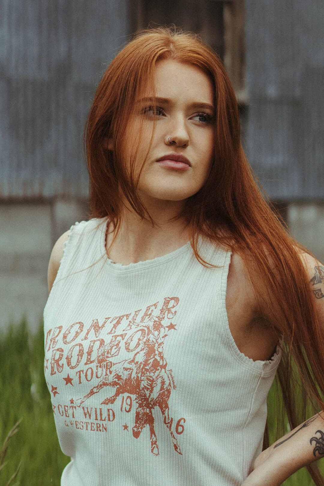 Close up image of the Rib Graphic Tee.   Tank style shirt.  Image of cowboy on horse,  Cream colored.