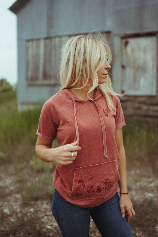 Woman modeling the Short Sleeve Embroidered Hoodie by Rock & Roll Denim.  