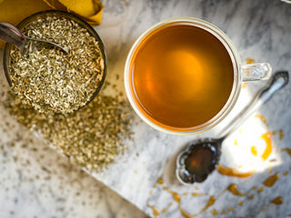 An overhead shot of the mug of Yerba Mate Tea with the dried herb in the background.