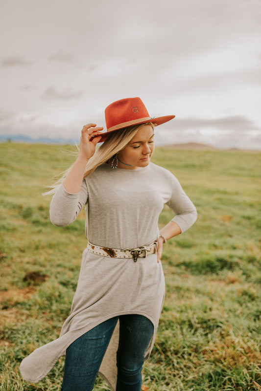 Woman standing in field modeling the Burgundy Charlie 1 Horse Teepee Hat.  