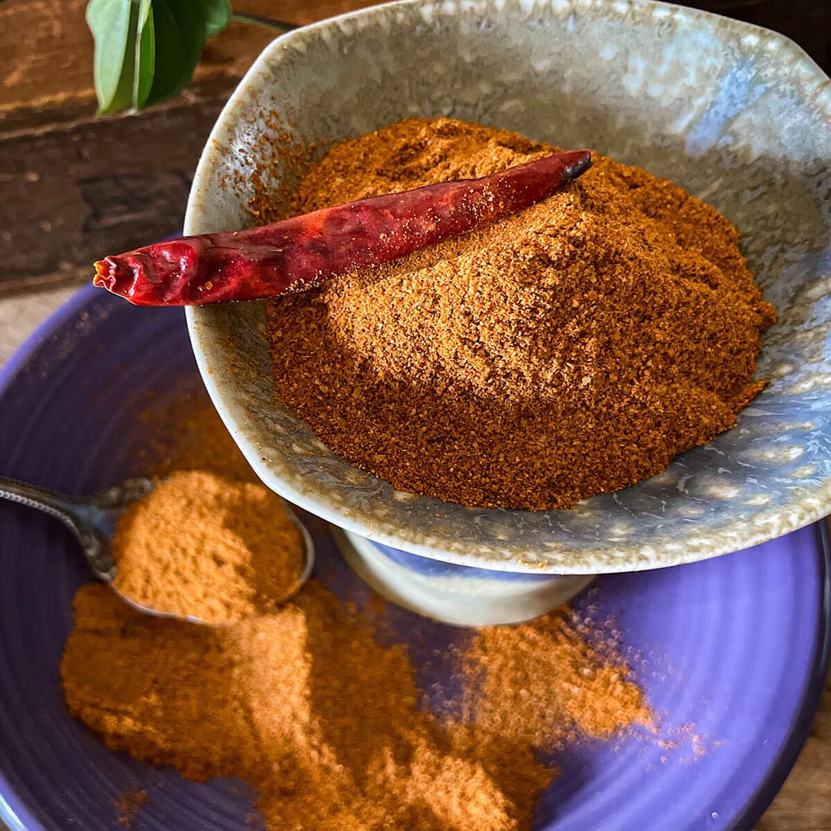 Cajun spice blend in bowl with dried pepper