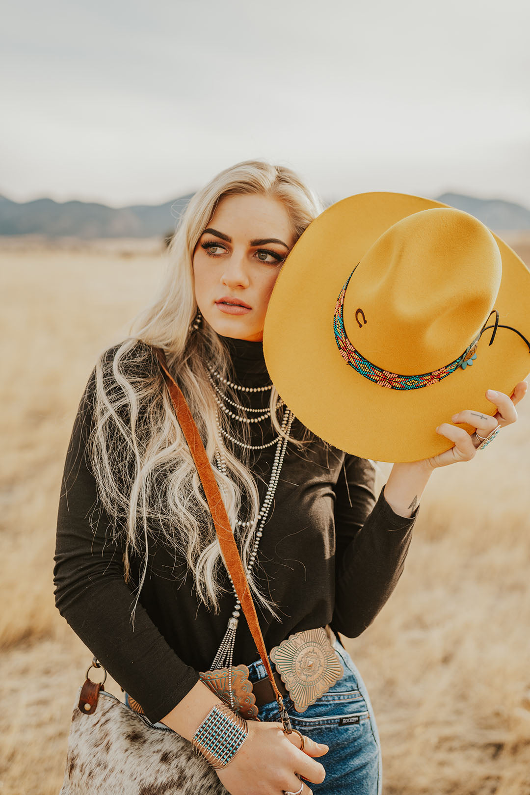 Woman modeling the Gold Digger Yellow Cowgirl Hat by CHarlie 1 Horse.  