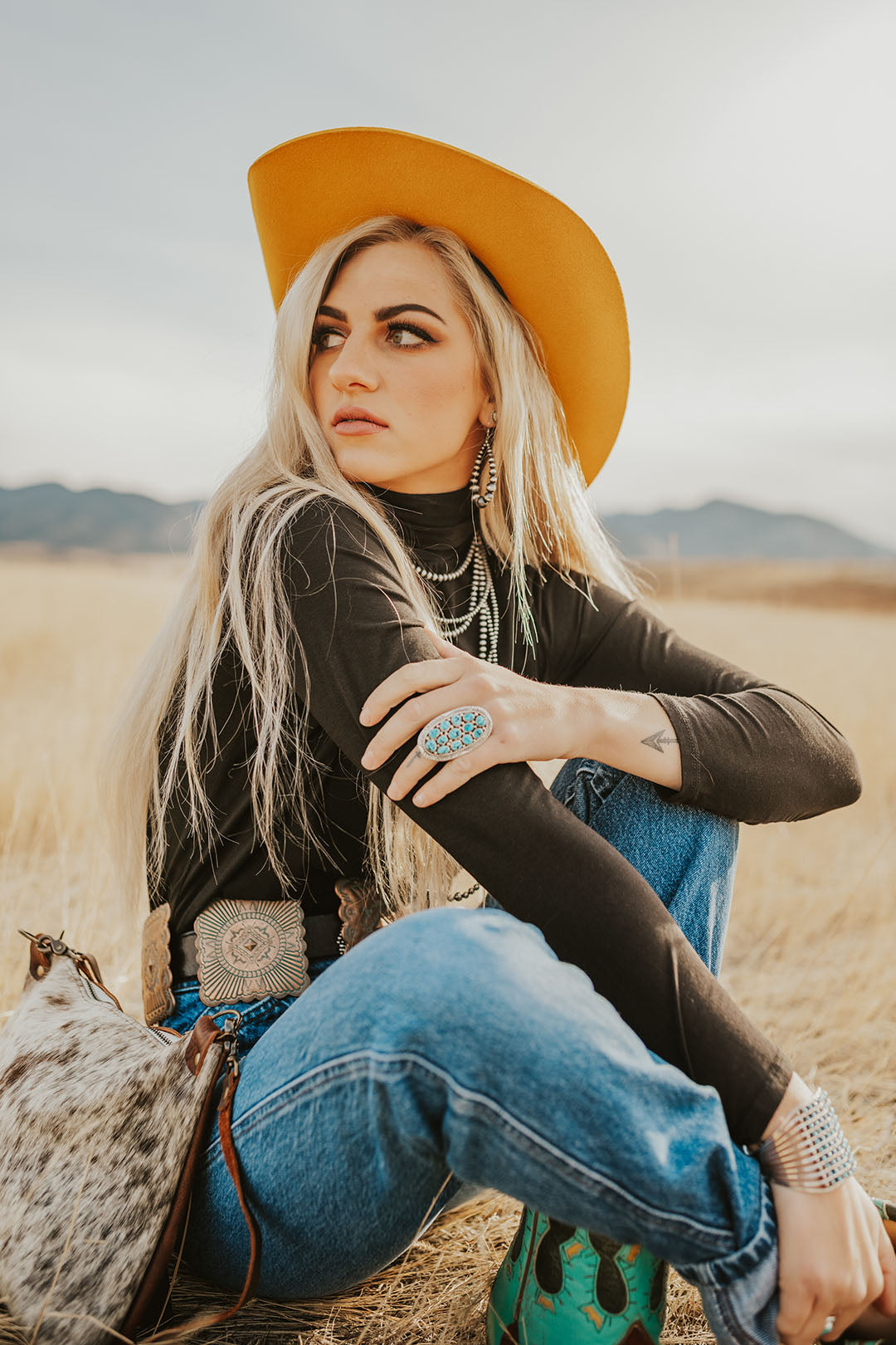 GIrl sitting in field wearing the Gold Digger Yellow Cowgirl Hat by Charlie 1 Horse.
