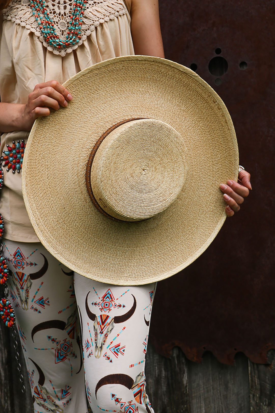 Woman holding the Vaquera Cowgirl Hat.  Has brown band.