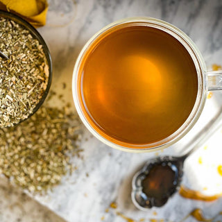 An overhead shot of the mug of Yerba Mate Tea with the dried herb in the background.