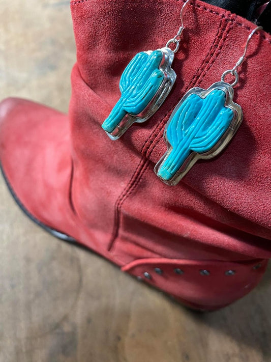 turquoise earrings on red boot.