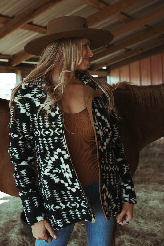Woman modeling the alder berber pattern zip thru jacket by Pendleton.  The jacket is zip up.