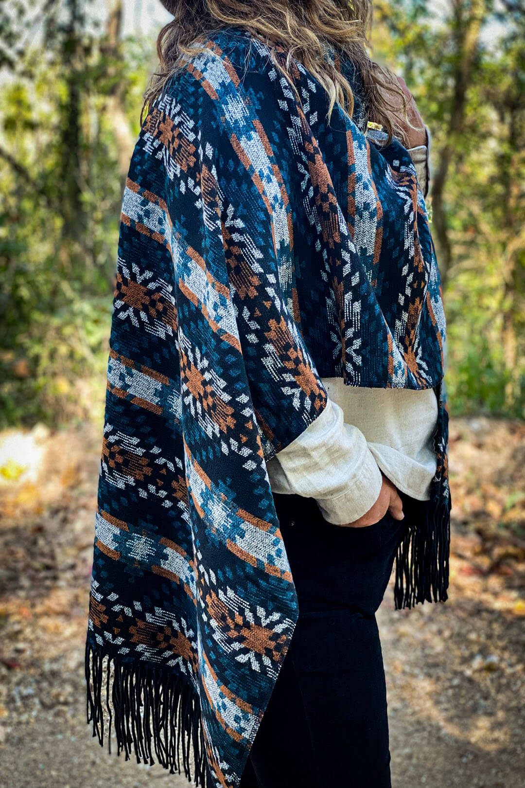 Picture showing detail of poncho with aztec design and fring on each side