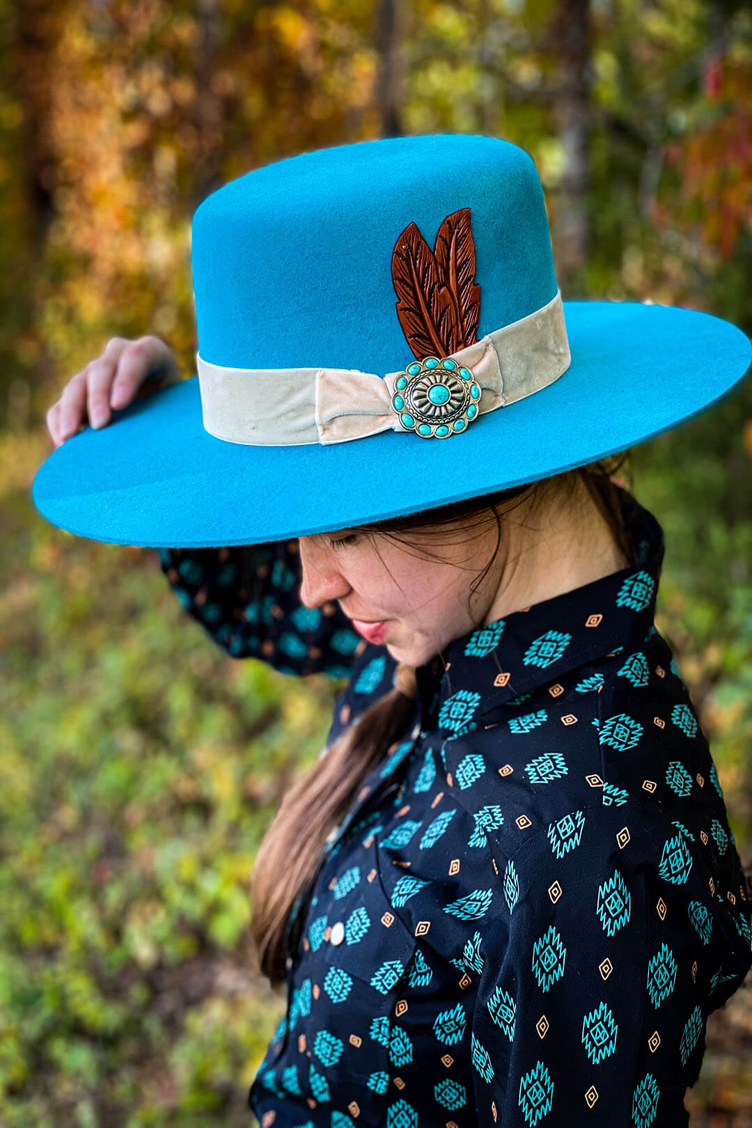 Bohemian Turquoise charlie 1 horse cowgirl hat featuring feather and tan wrap around band with turquoise stone concho