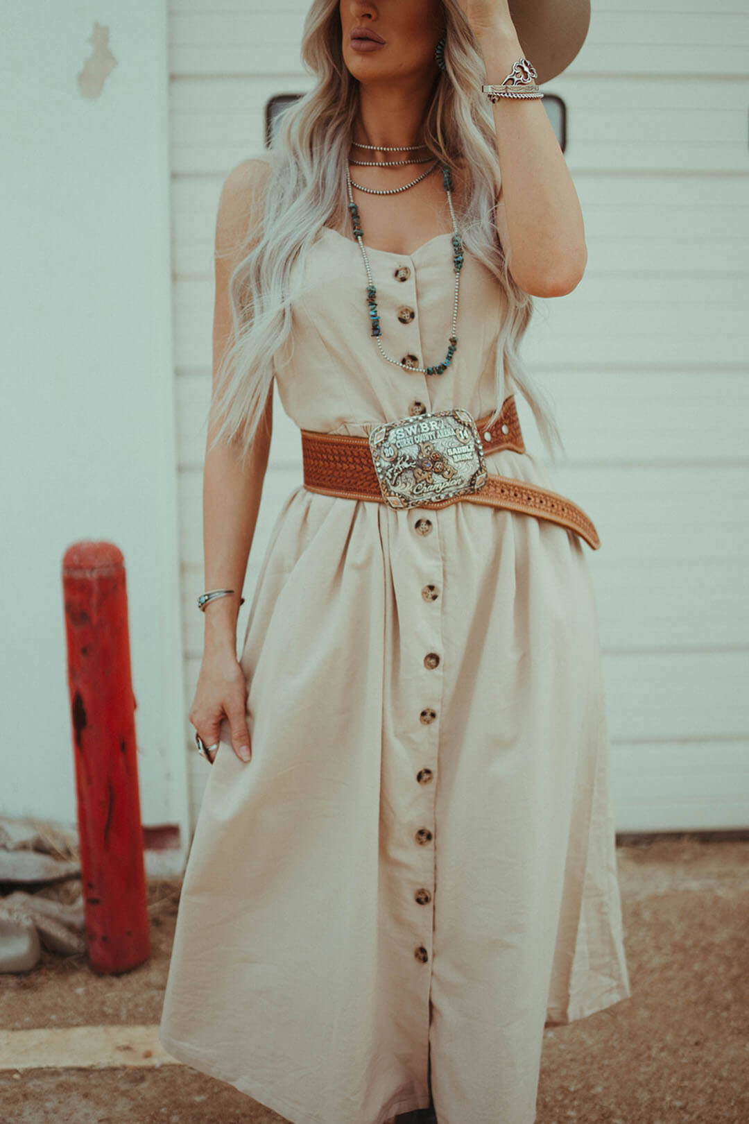 Woman modeling the Button Down Midi Dress.  The dress can be worn with or without belt.  The picture is shown with a belt. 