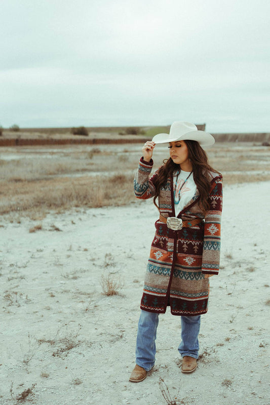This beautfiul button down front navajo blanket duster with hood by Cripple Creek features unique aztec print with various colors of red orange blue and cream. 