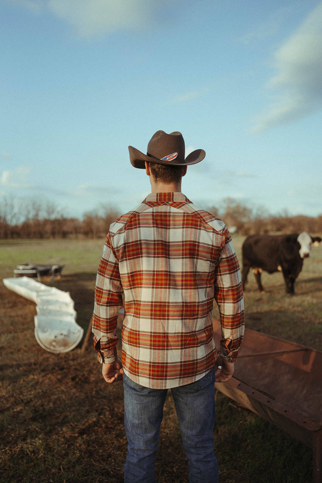 Man modeling the back of the fremont flannel pendleton shirt in the cream/red/brown color.  Button sleeve closure.  