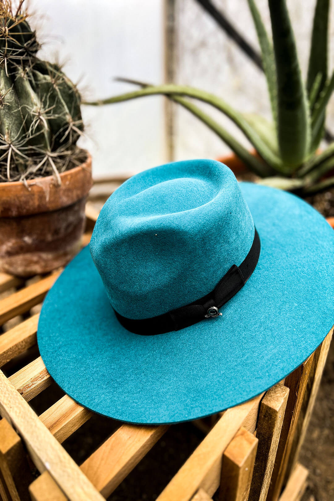 Side image of the Highway Teal Cowgirl Hat by Charlie 1 Horse.  The hat has a black band. 