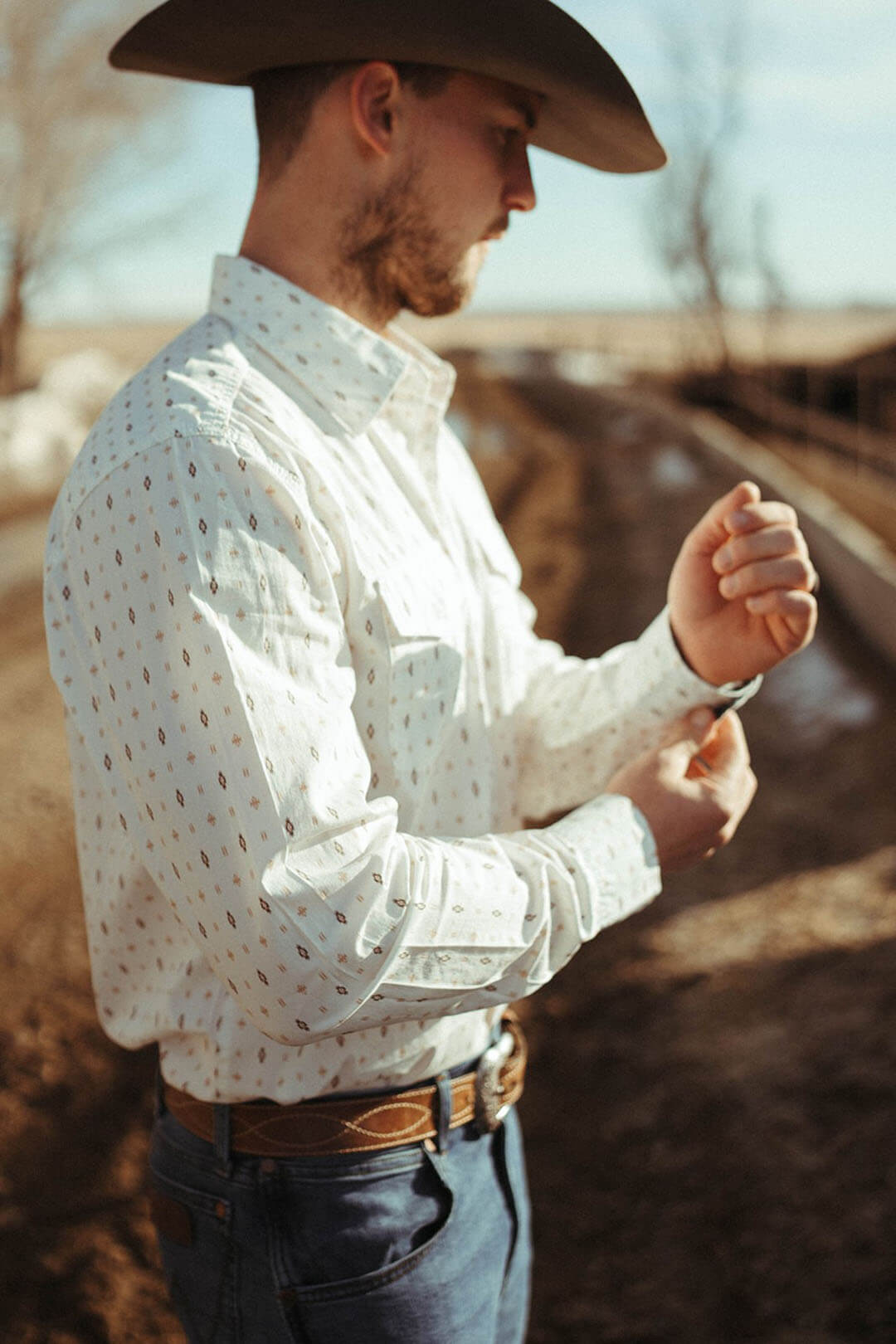 Man modeling the Mens Retro Long Sleeve White Button Up Long Sleeve Shirt.  Features 2 chest pockets and button cuff closure.