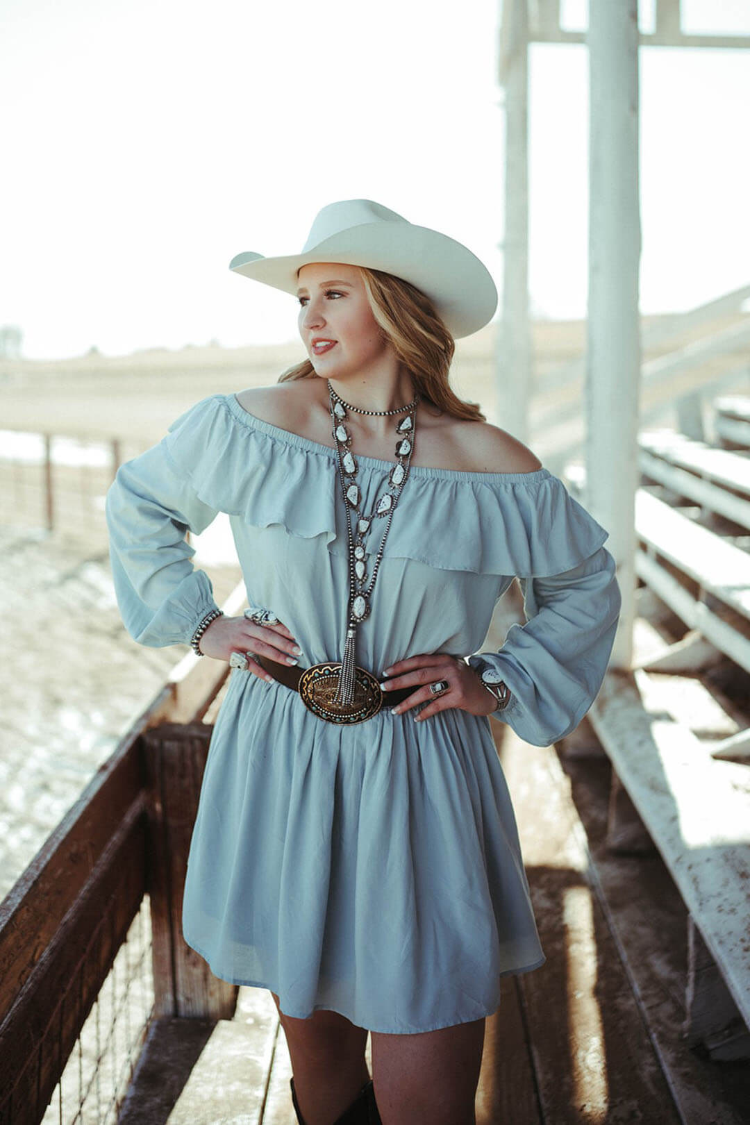 Woman modeling the Off the Shoulder Mint Wrangler Dress.  The dress features ruffle detail around top. 