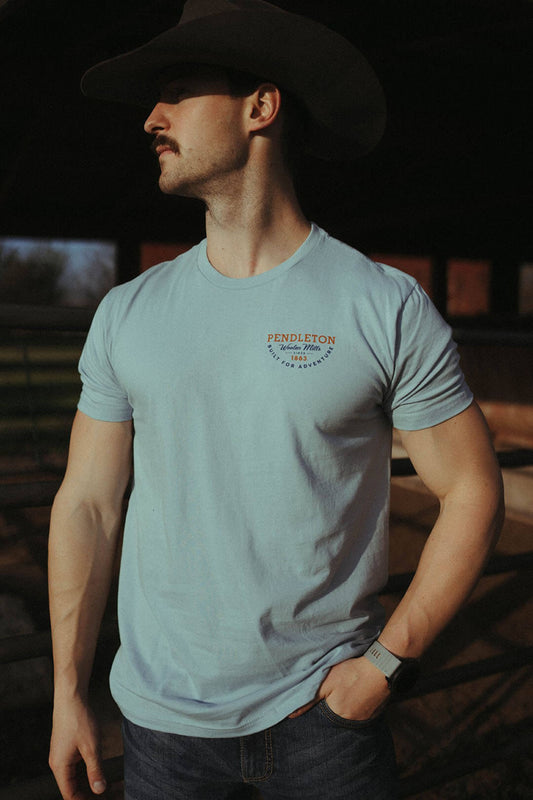Man modeling the Pendleton 1863 graphic tee shirt.  Has Pendleton logo on left side of chest.
