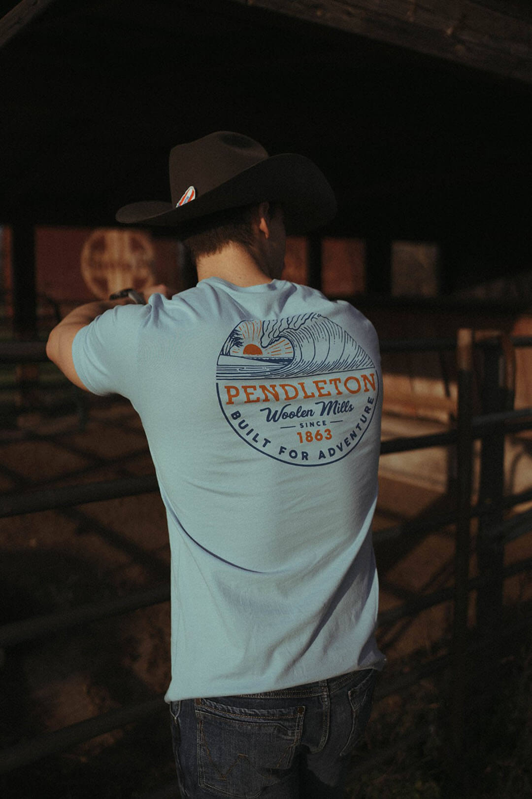 Back side picture of the pendleton graphic tee with picture of a wave.  The shirt is light blue in color.