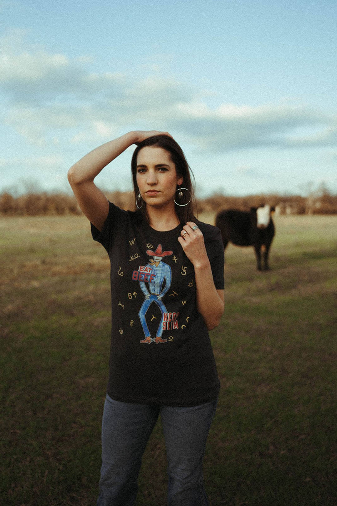 Woman modeling the "Eat Beef, Keep Slim" graphic shirt by XOXO art & company.  