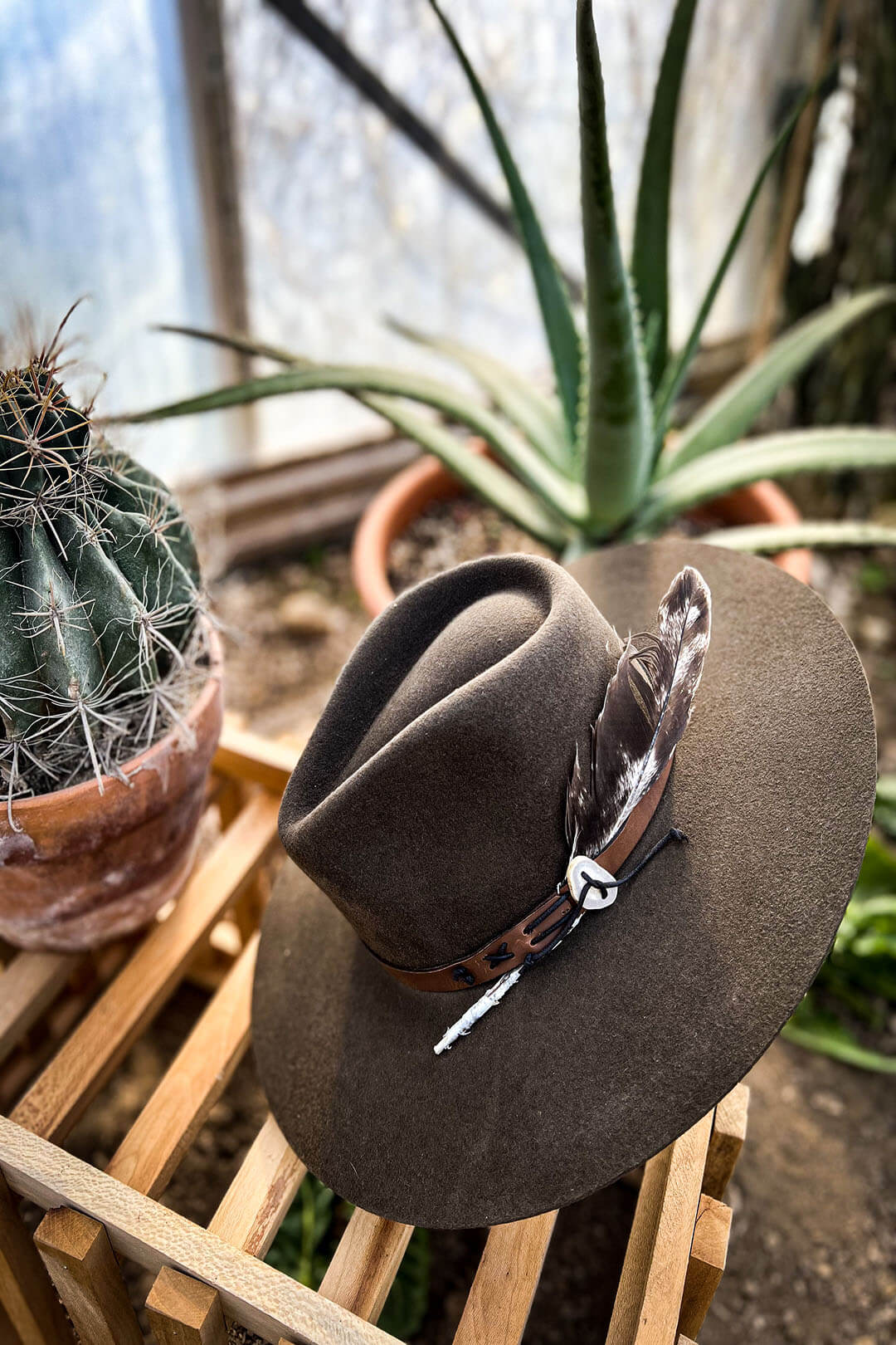 Image of the TeePee Oak Cowgirl Hat by Charlie 1 Horse sitting on a crate.  