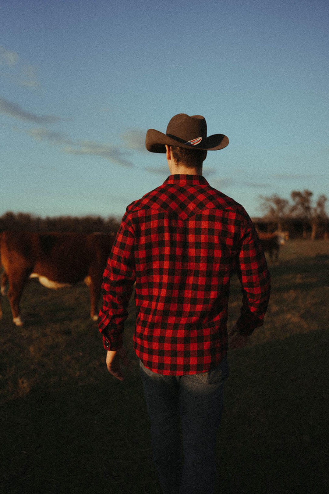 Man modeling the back of the Wrangler Retro Buffalo Plaid pearl snap long sleeve shirt.  with pearl snap cuff closure. 