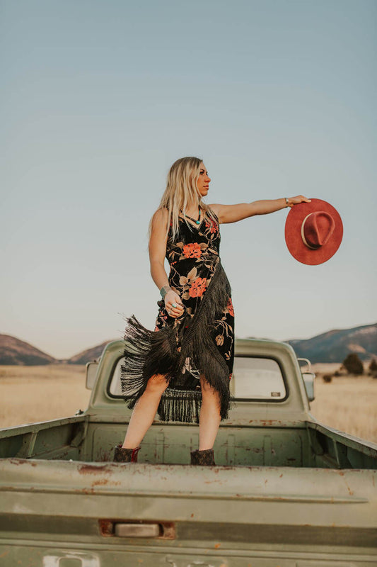 WOman standing in back bed of truck holding the Highway Burgundy Cowgirl Hat by Charlie 1 Horse.  