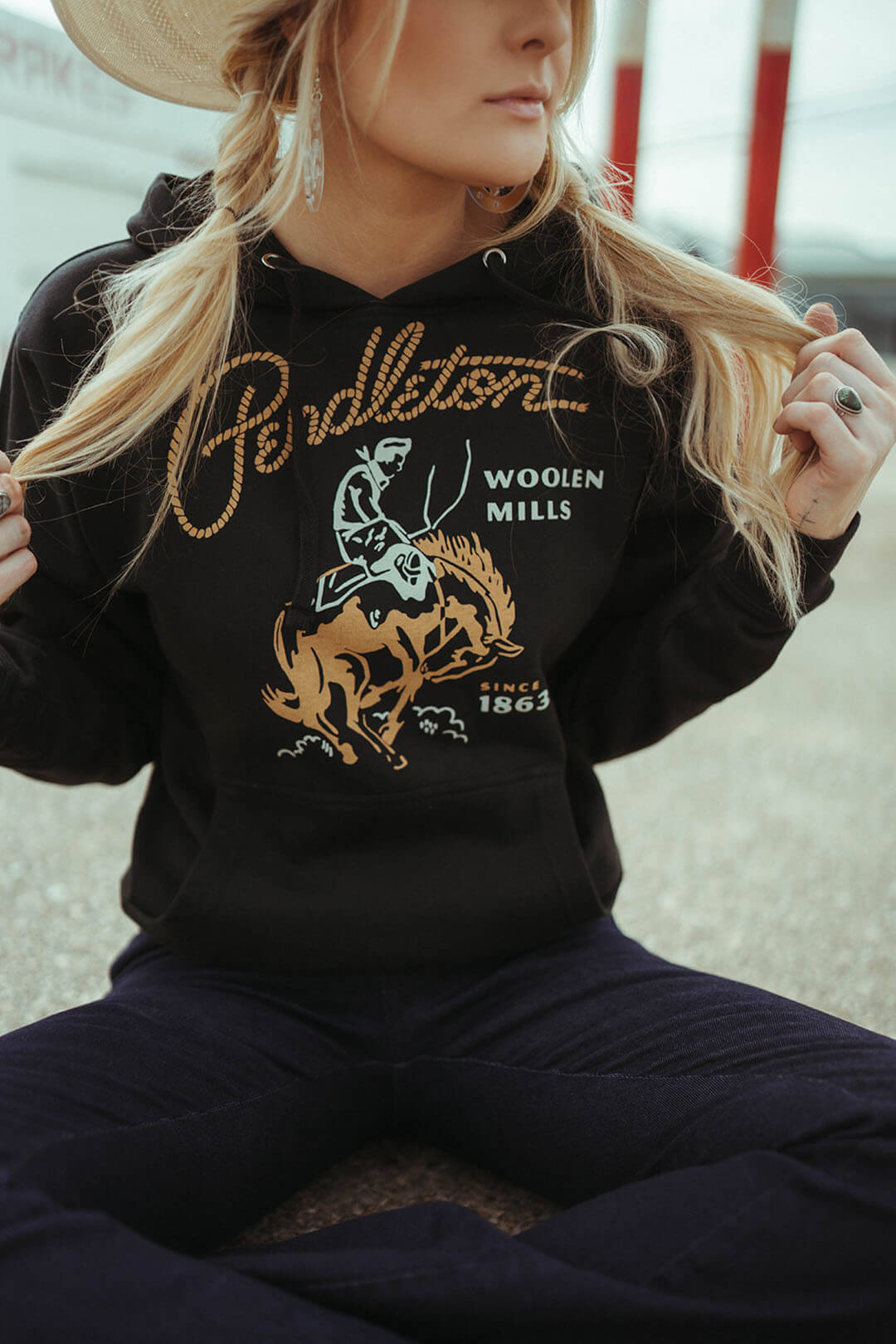 Close up image of the rodeo hoodie by pendleton.  The hoodie says Pendleton Woolen Mills Since 1863.  It features a straw string tie and kangaroo pouch.